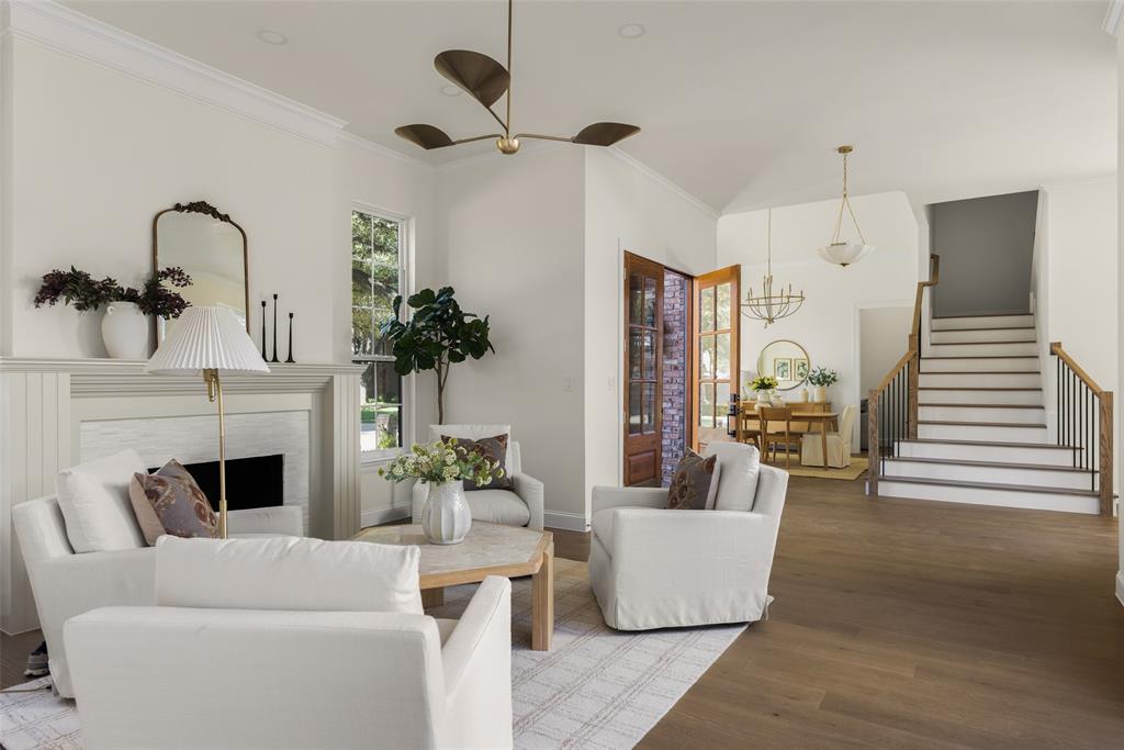 Open floor plan with livable flow, connects the front living room with the entry, staircase, and formal dining area while maintaining clearly defined spaces.