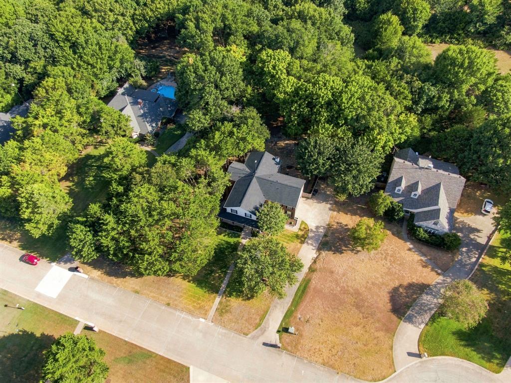 Bird's-eye view of the home tucked among beautiful towering trees