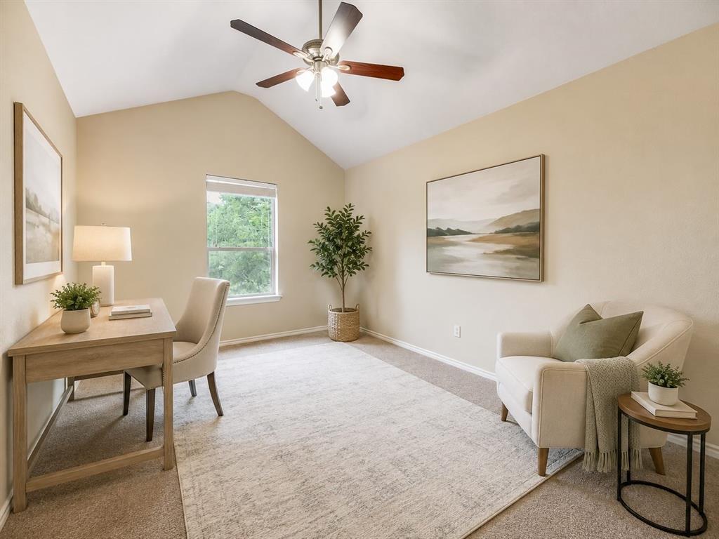 Vaulted ceiling, ceiling fan with integrated lighting, carpeted flooring, window with natural light, neutral wall colors