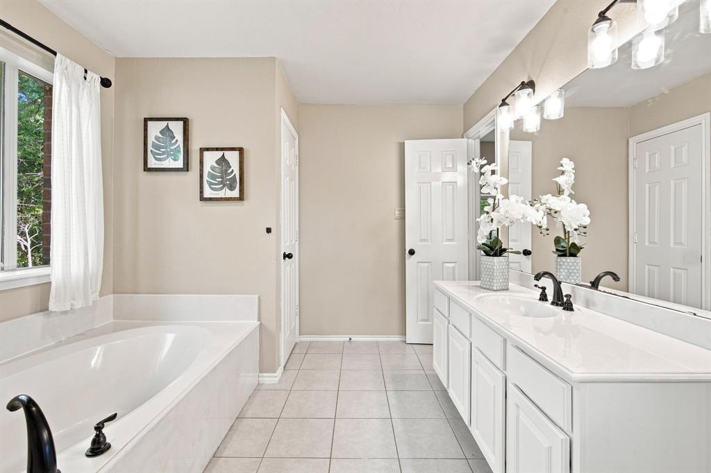 Elegant vanity with undermount sink, matte black faucets, and a large mirror for a spa-like feel.