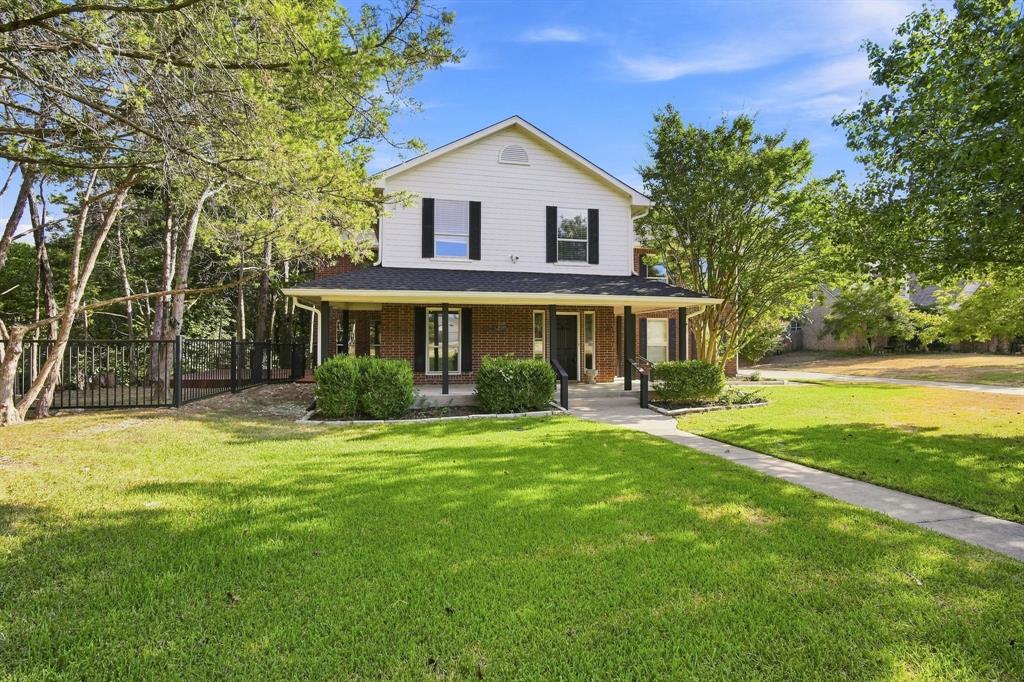 A striking two-story exterior with brick and siding, a columned front porch, and a classic gabled roofline welcomes you home.