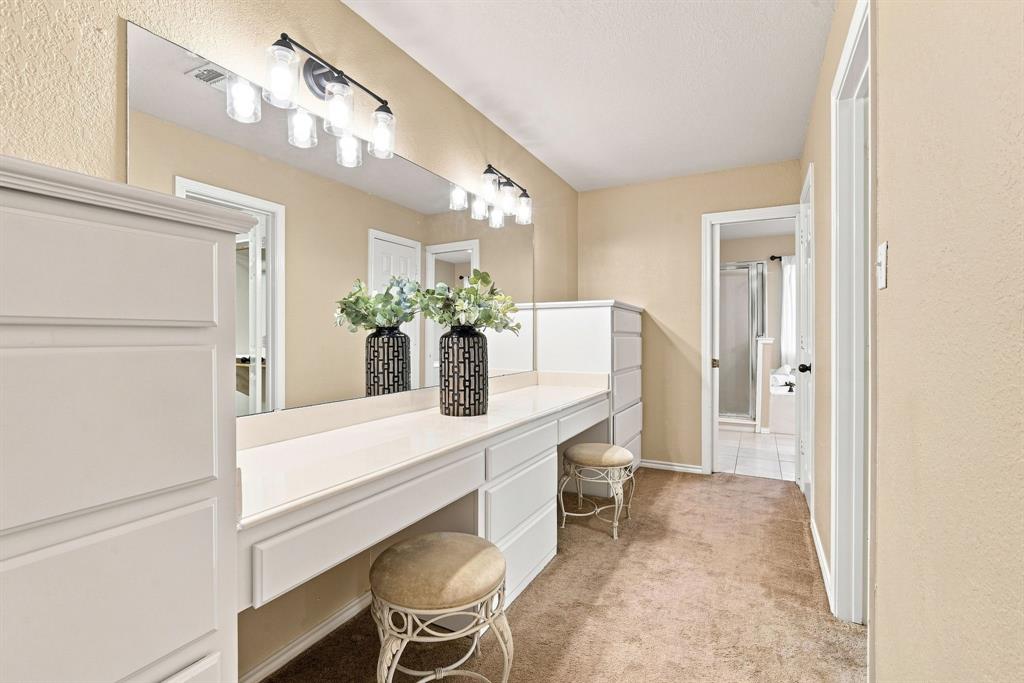 Dedicated vanity and get-ready space with a long countertop, statement mirror with vanity lighting, and built-in storage, the perfect spot to start your day.