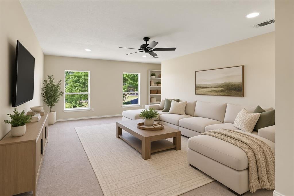 Spacious upstairs living area with abundant natural light, built-in shelving, and plenty of room for a media room, game room, or second family room.