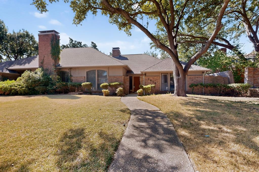 Single-story brick exterior with a pitched roof, front entry pathway, mature trees, and established landscaping Single-story brick exterior with a pitched roof, front entry pathway, mature trees, and established landscaping