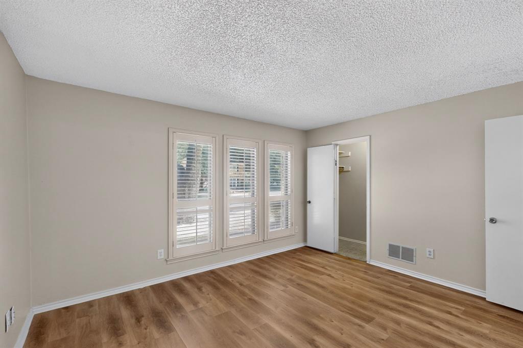 Wood-finish flooring, neutral wall paint, and white trim