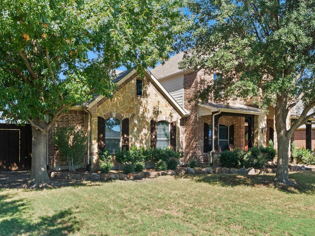 Home has a covered patio and mature trees facing the community pool