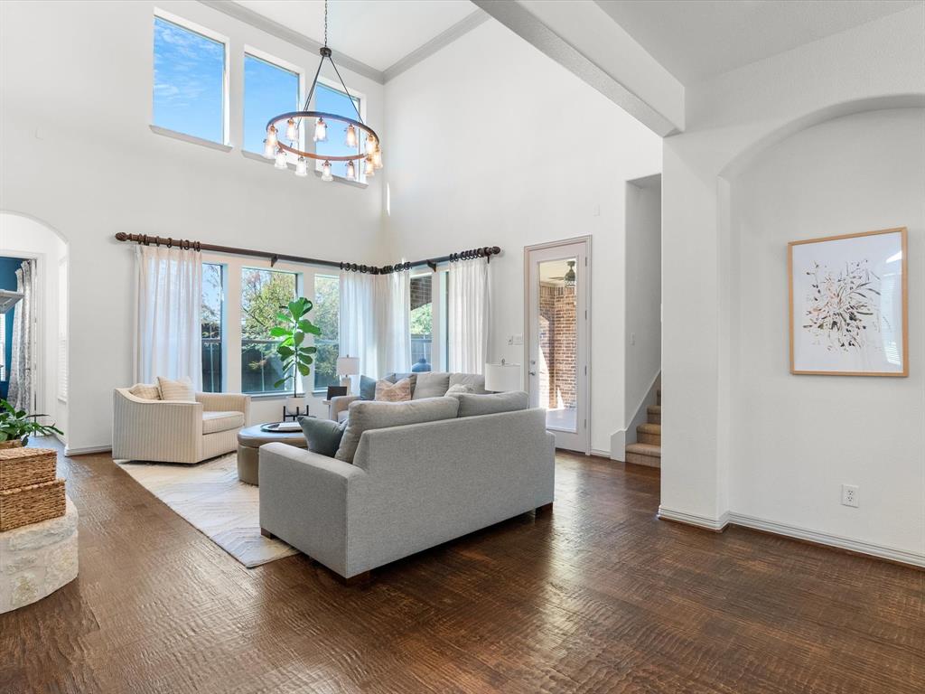 Primary living space with soaring ceilings and updated lighting