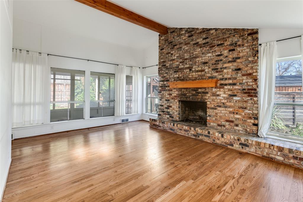 Gas FP; view through windows to sunroom. Beautiful hardwoods. Gas FP; view through windows to sunroom. Beautiful hardwoods.