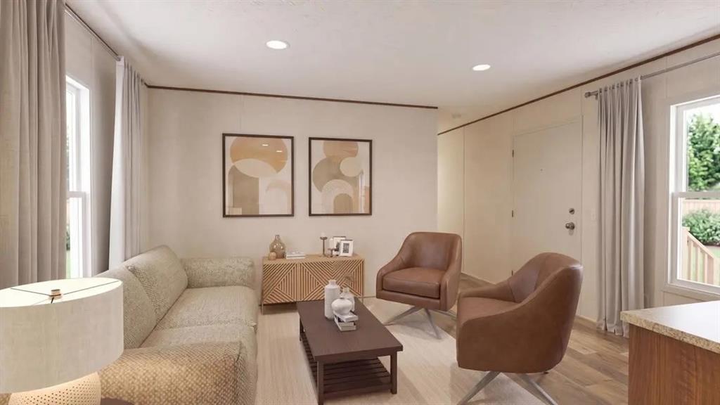 Open concept living area featuring recessed lighting, wood-finish flooring, and multiple windows with neutral wall tones