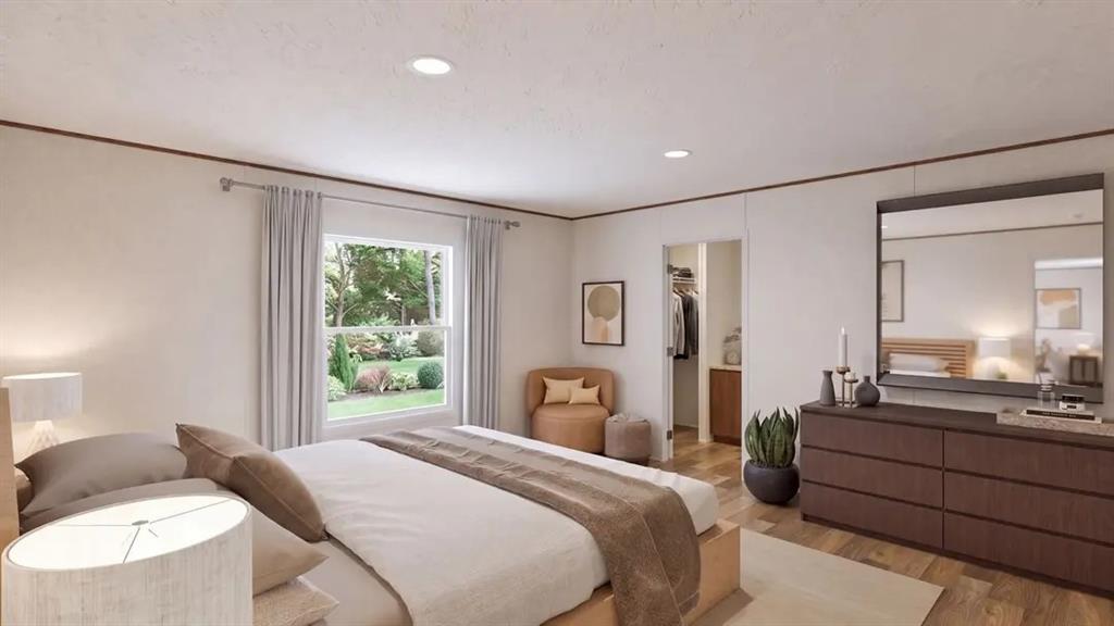 Interior room featuring wood-finish flooring, recessed lighting, and a window with exterior landscape exposure