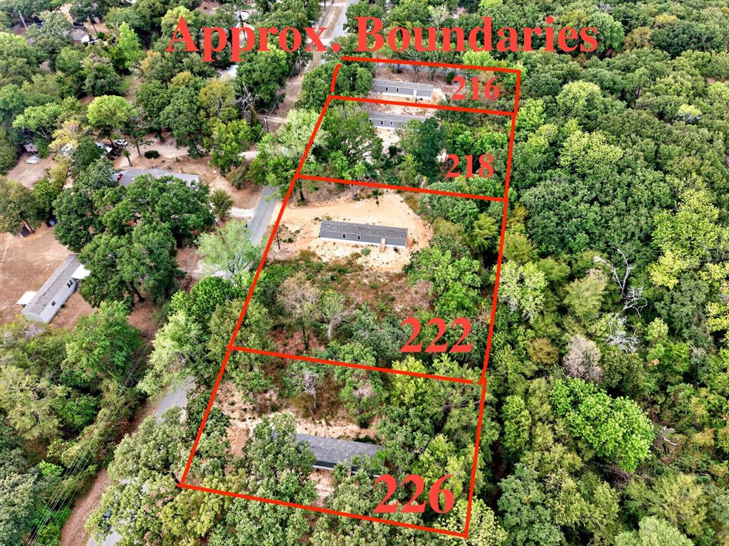 Aerial perspective of multiple parcels featuring substantial mature tree cover and varying terrain