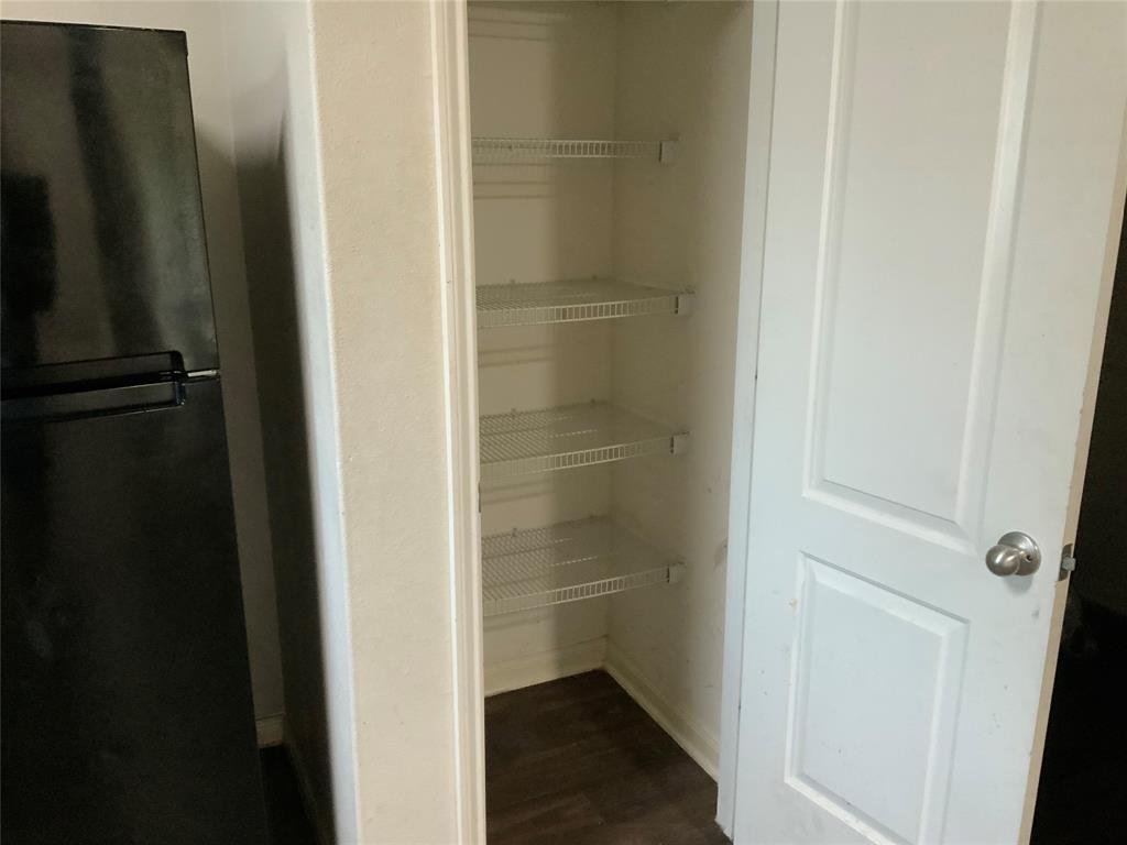 Built-in pantry with wire shelving and wood-finish flooring