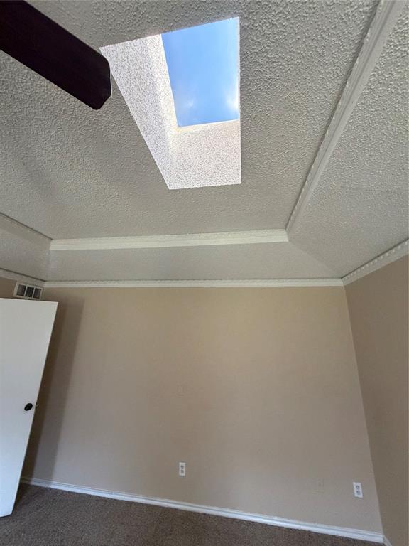 Recessed skylight, tray ceiling, ceiling fan, neutral wall paint, and white trim