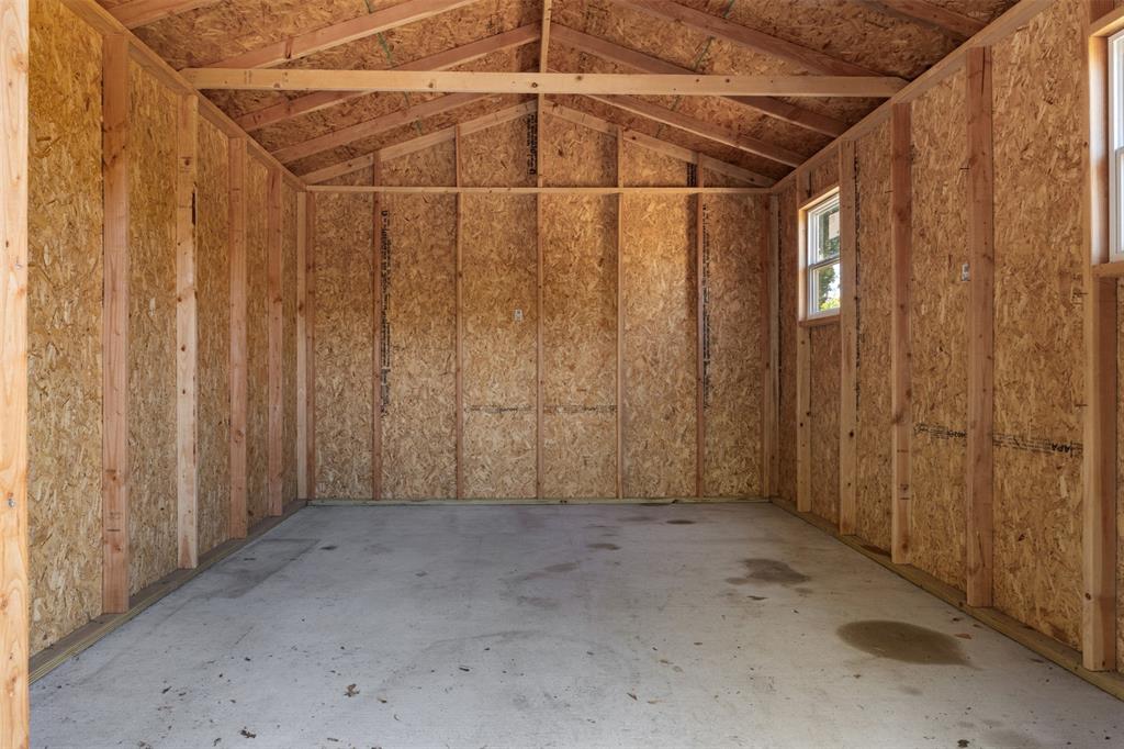 Unfinished interior with exposed wood framing and oriented strand board walls