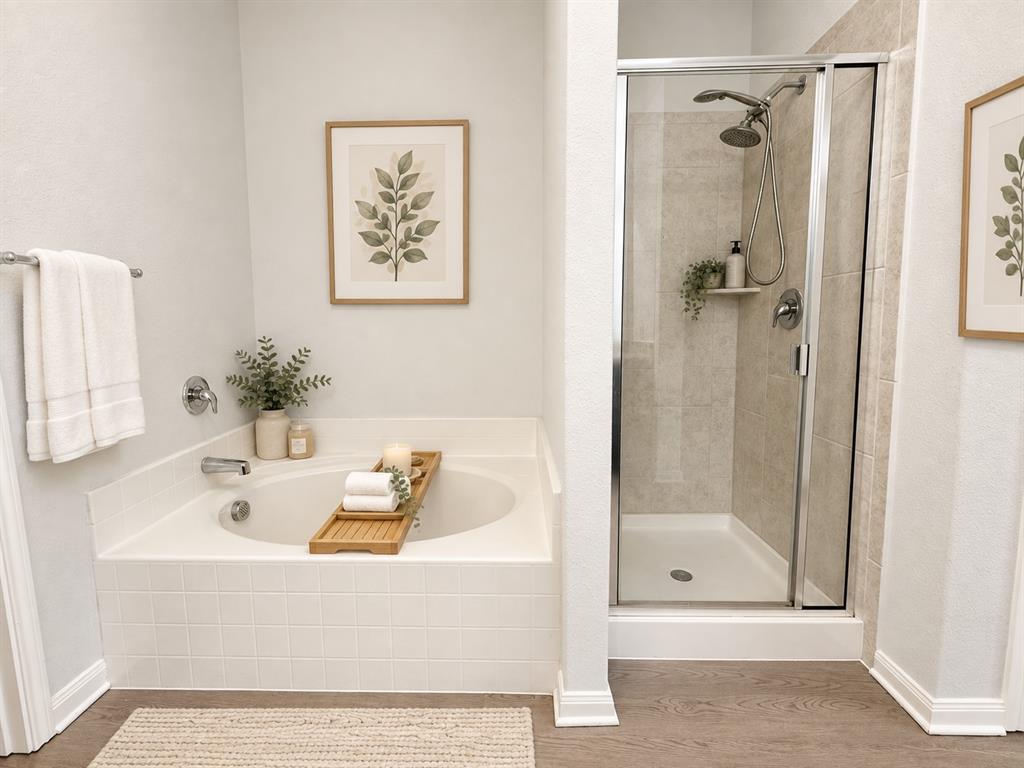 Soaking tub with white tile surround, adjacent to a glass-enclosed shower with tiled walls Soaking tub with white tile surround, adjacent to a glass-enclosed shower with tiled walls