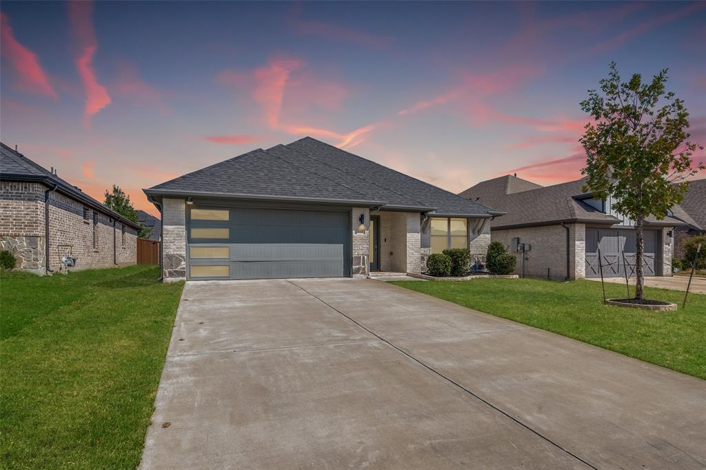 Brick and stone exterior with a dark gray shingle roof