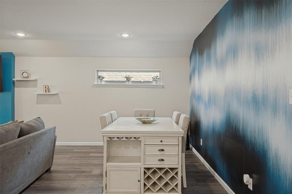 Wood-finish flooring throughout, recessed lighting, and a horizontal window Wood-finish flooring throughout, recessed lighting, and a horizontal window