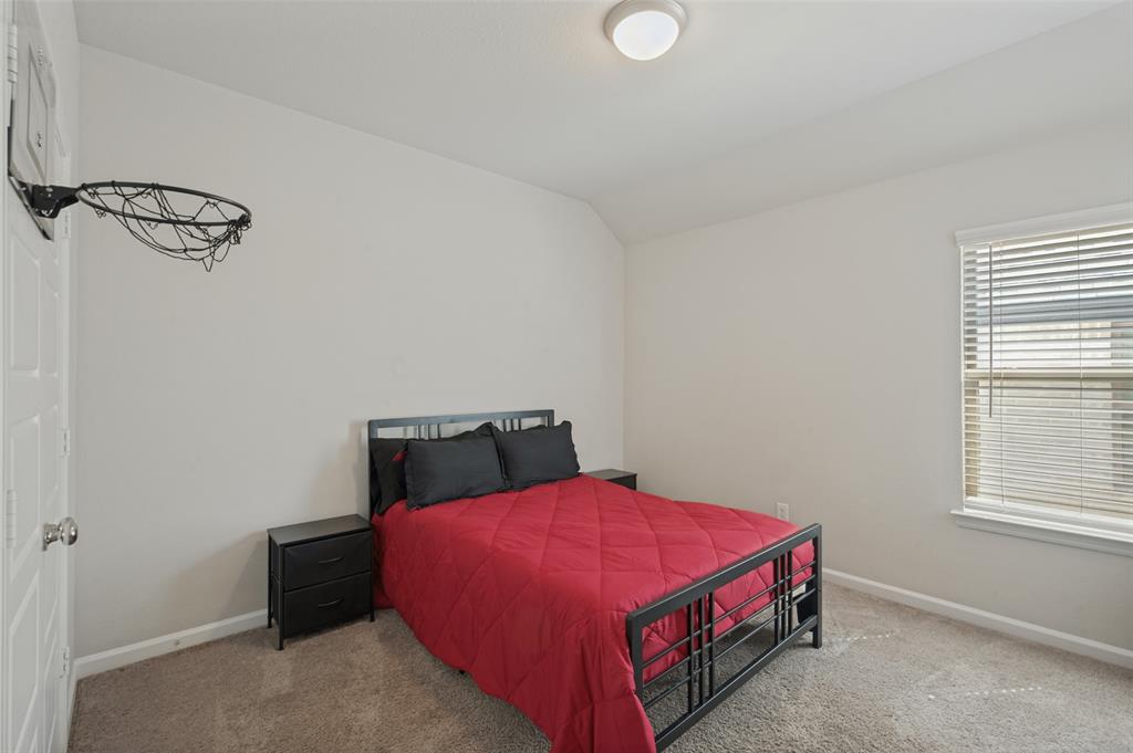 Carpeted room with a single window, white window blinds, and a flush mount ceiling light fixture
