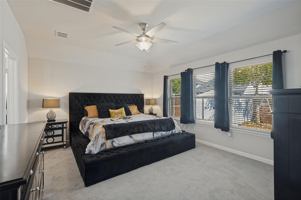 Recessed lighting, ceiling fan with integrated lighting, multiple windows, carpeted flooring, and neutral wall paint