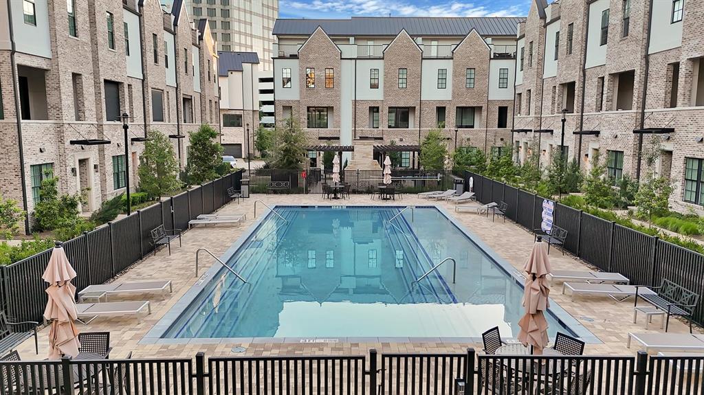Central swimming pool surrounded by paver decking