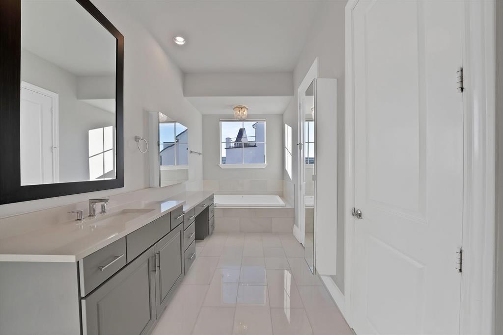 Dual vanity with modern gray cabinetry and light-toned countertops