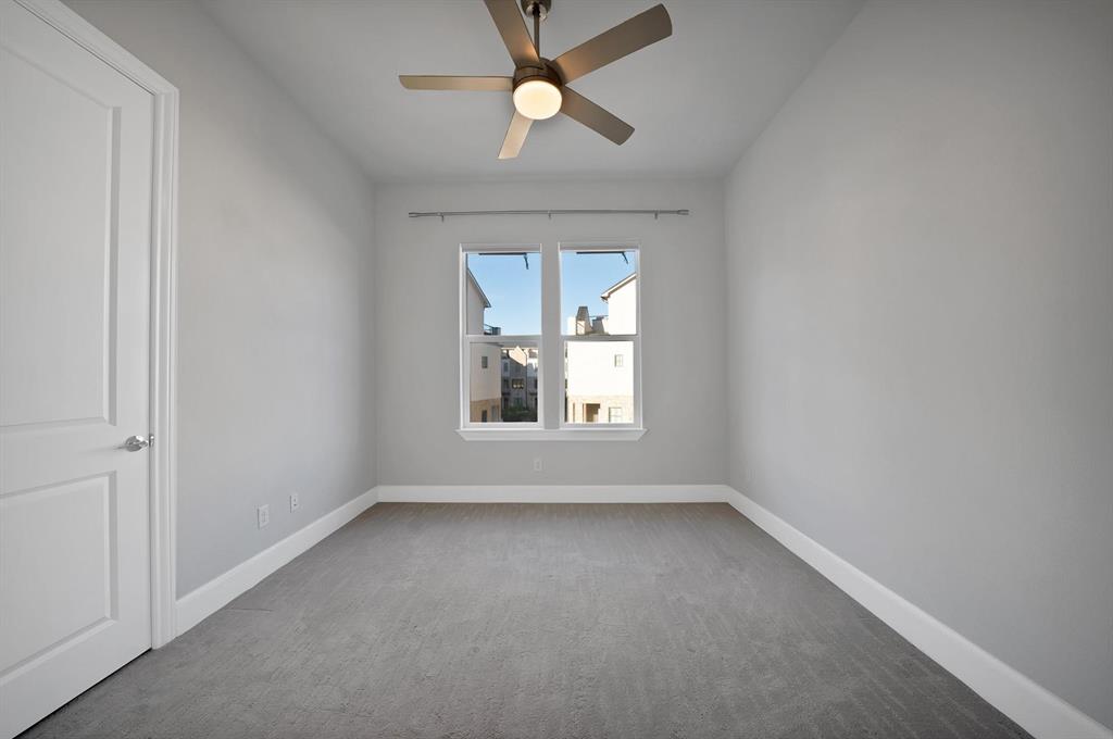 Recessed window with white trim, a flush-mount ceiling fan with integrated lighting, and neutral-toned wall-to-wall carpeting