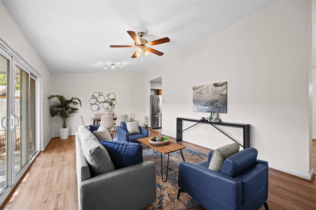 Vaulted ceilings, wood-finish flooring, ceiling fan, and sliding glass doors