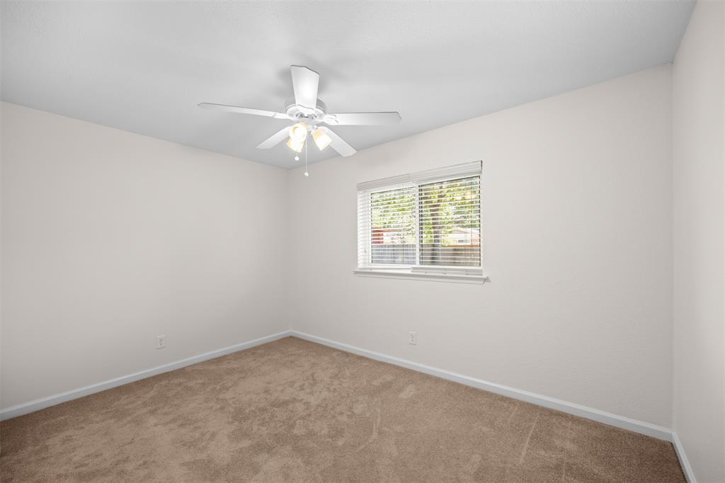 Neutral-toned walls complement the plush carpeting