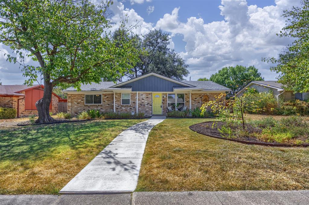 Brick exterior with blue siding accents, covered front porch, and a vibrant yellow entry door Brick exterior with blue siding accents, covered front porch, and a vibrant yellow entry door