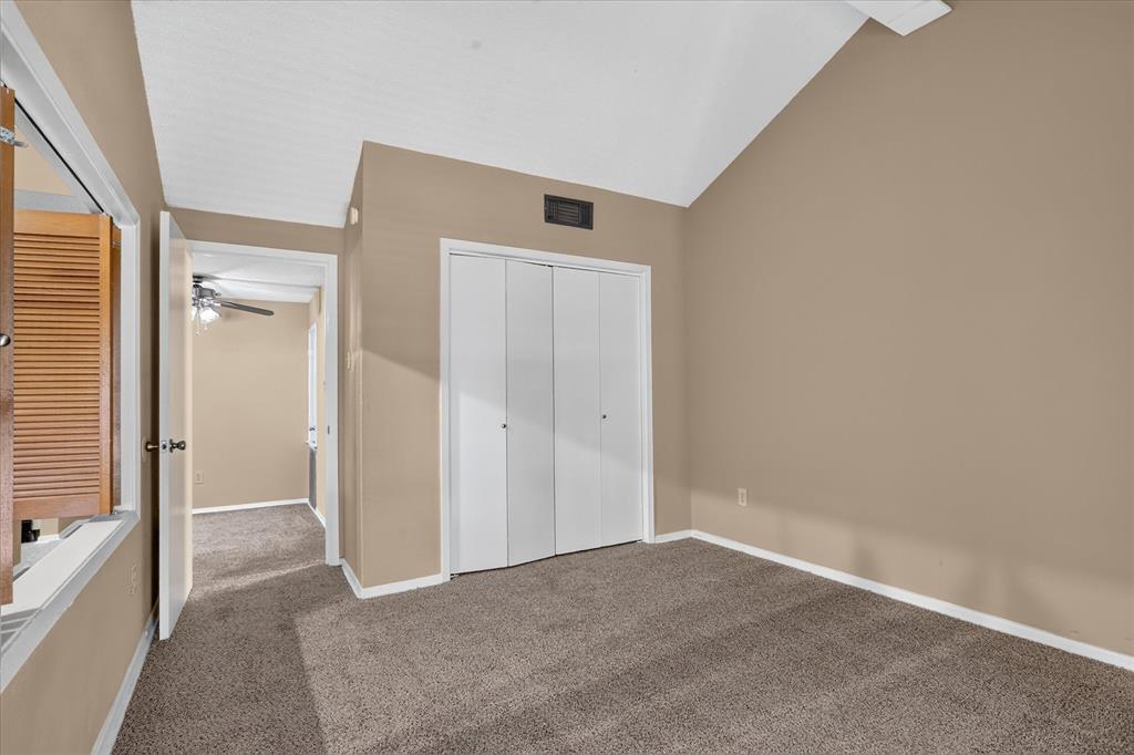 Vaulted ceiling, carpet flooring, bi-fold closet doors, louvered window shutters, recessed light fixture