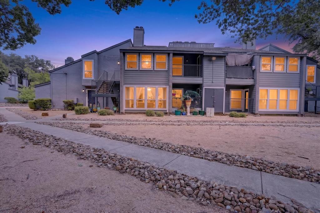 Two-story exterior with multiple balconies and ground-level patios Two-story exterior with multiple balconies and ground-level patios