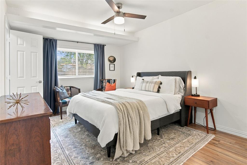 Wood-finish flooring with a ceiling fan, recessed lighting, and white paneled door
