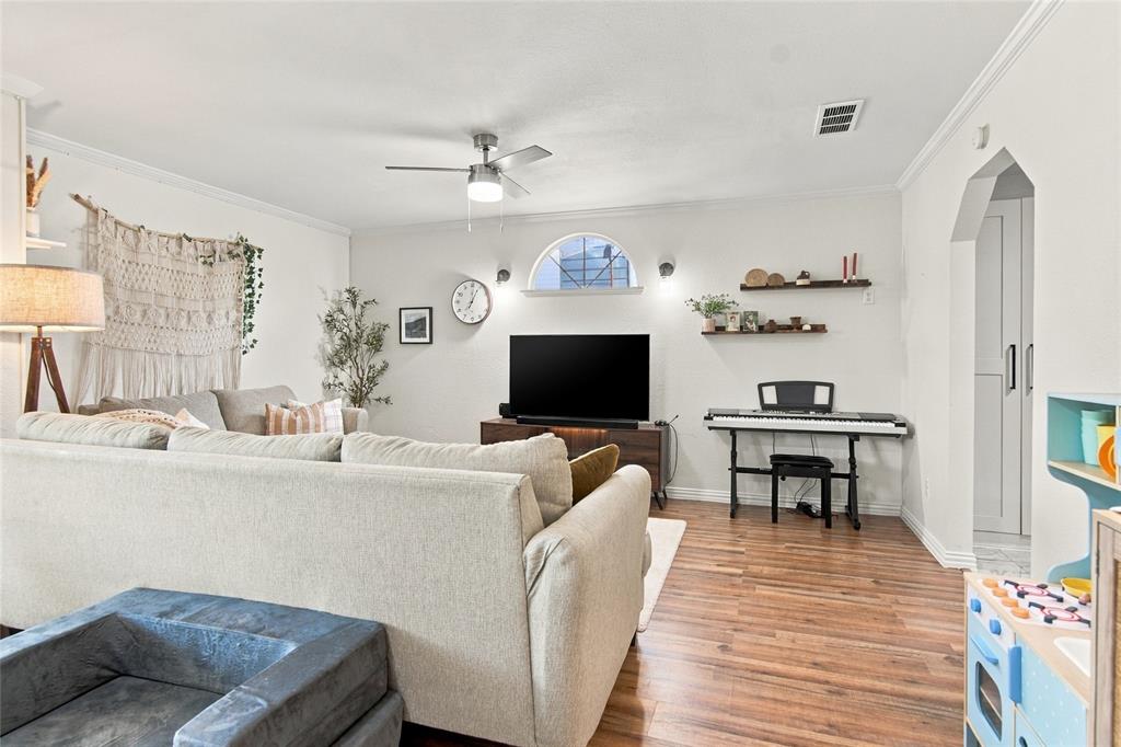 Wood-finish flooring throughout, complemented by a ceiling fan with integrated lighting Wood-finish flooring throughout, complemented by a ceiling fan with integrated lighting