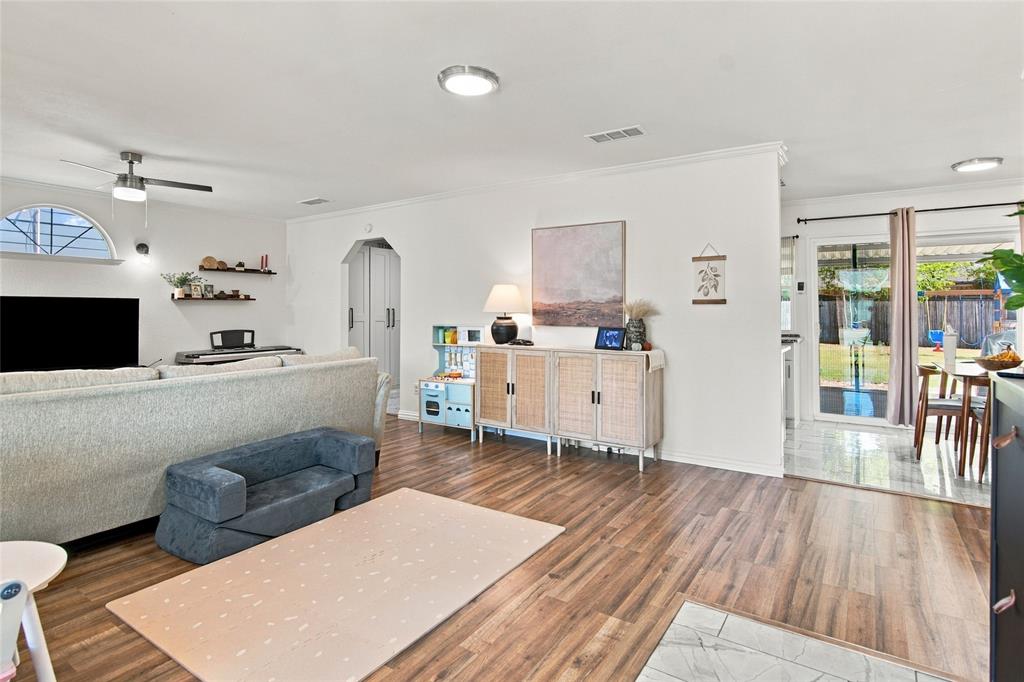 Wood-finish flooring throughout, recessed lighting, and a ceiling fan Wood-finish flooring throughout, recessed lighting, and a ceiling fan