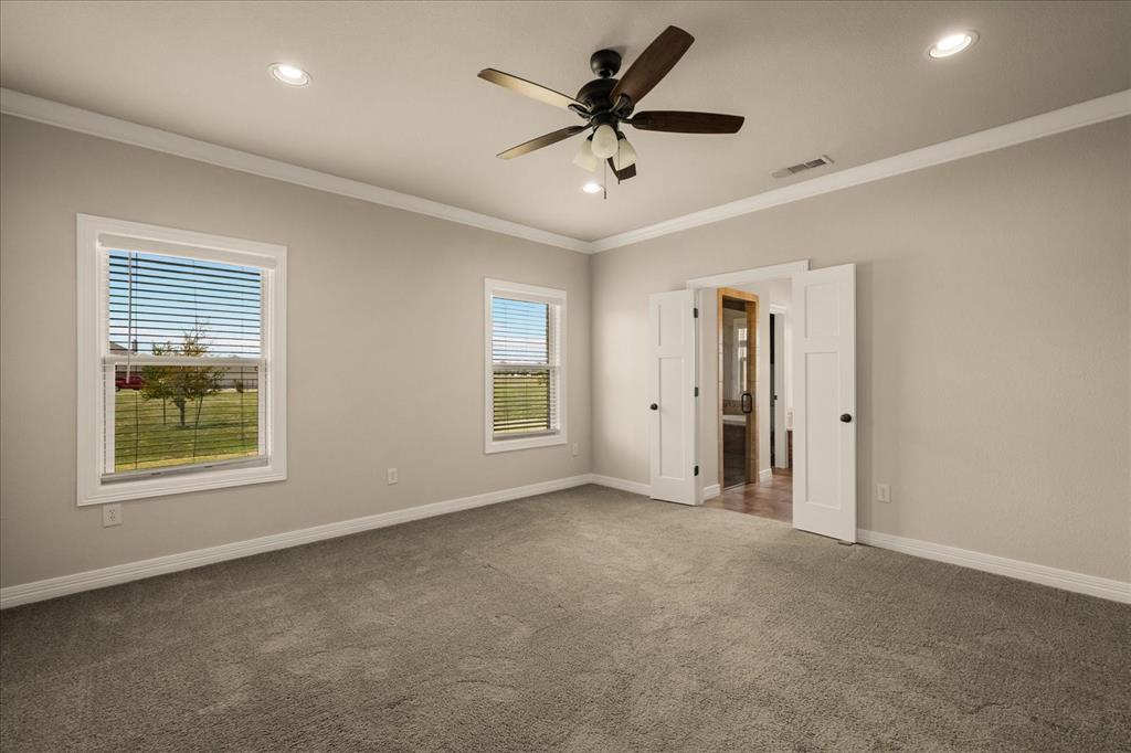 Recessed lighting, ceiling fan with light fixture, dual windows, neutral wall tones, and carpeted flooring