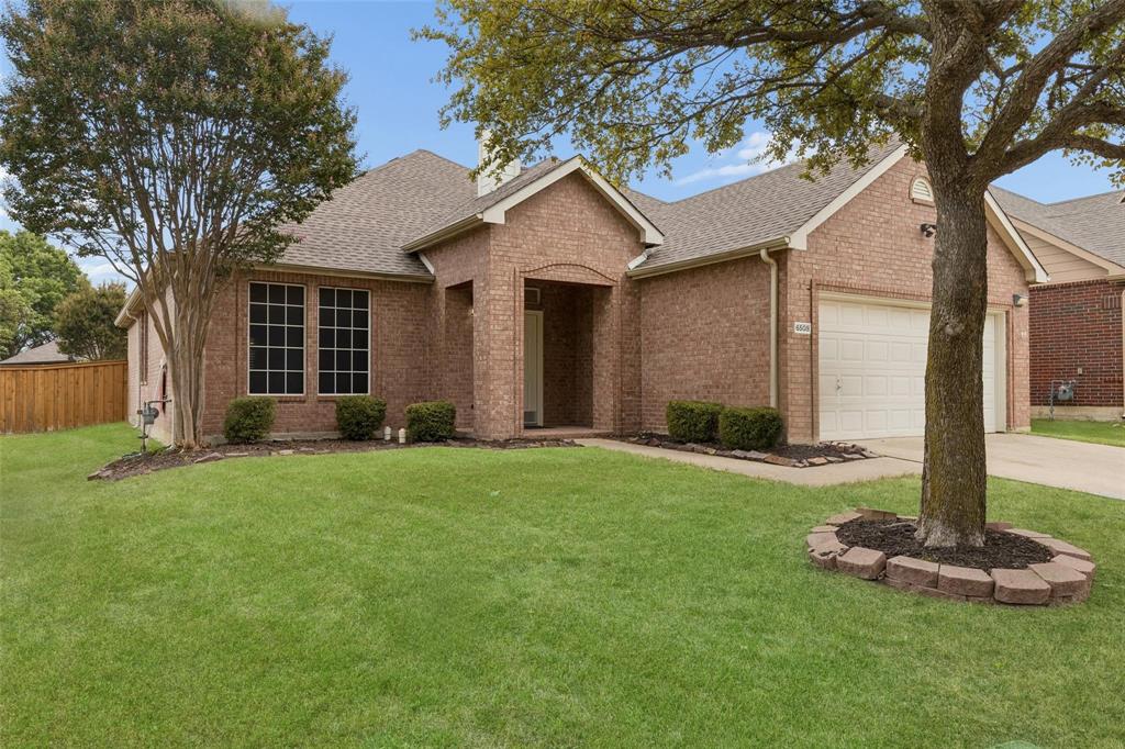 Brick exterior with an attached garage, covered entry, and large front windows