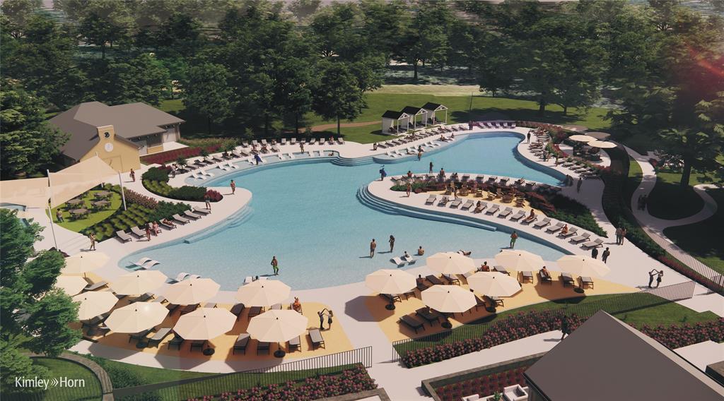 Expansive resort-style pool with multiple wading areas, surrounding lounge seating, and shaded areas