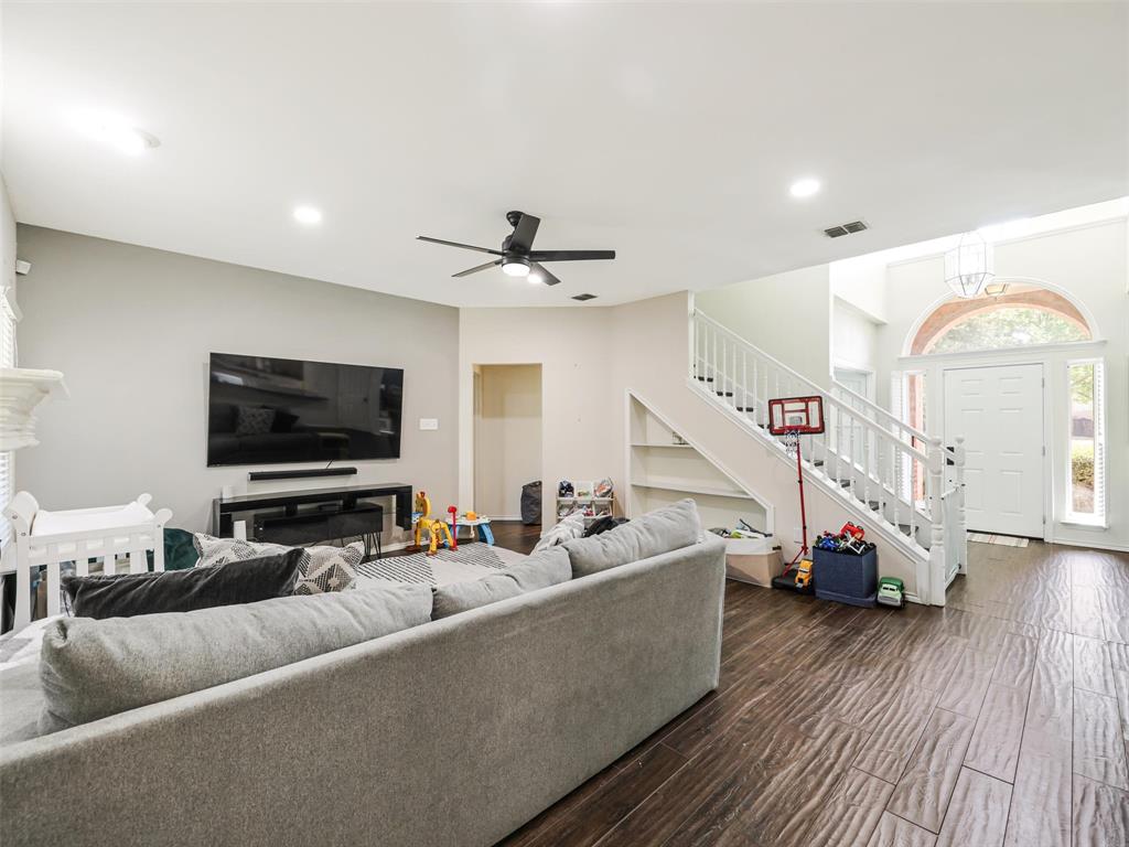 Wood-finish flooring, recessed lighting, and a white staircase with built-in shelving