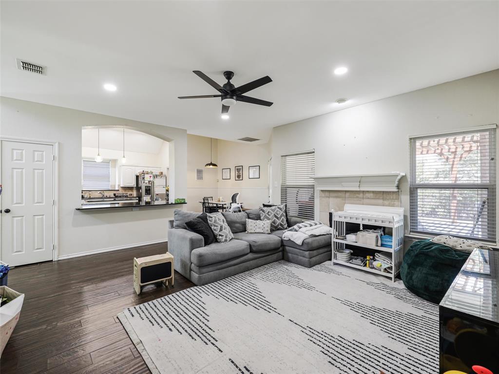 Spacious living area featuring wood-finish flooring, recessed lighting, and a ceiling fan