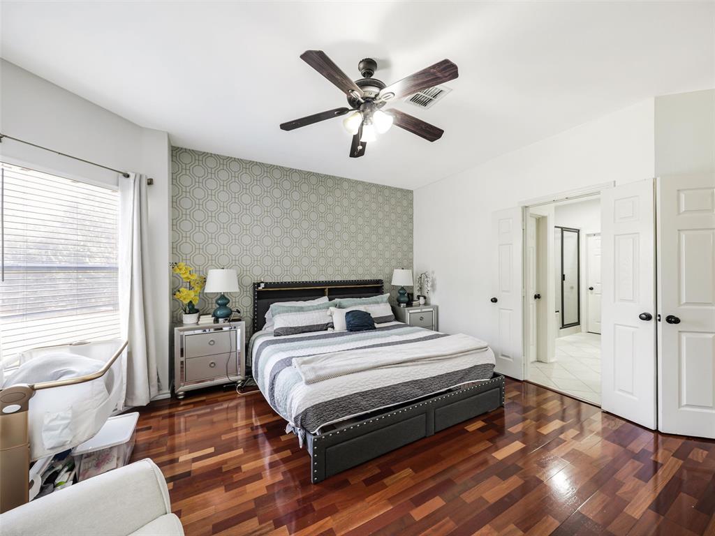 Hardwood flooring, ceiling fan, accent wall, French doors, and recessed lighting