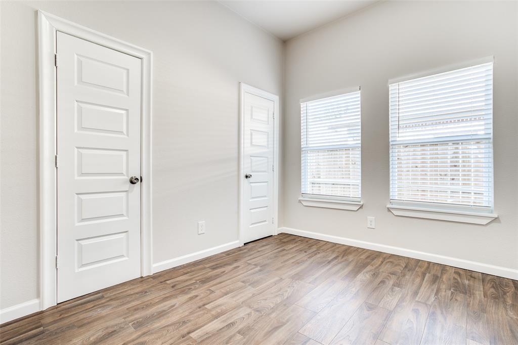 Unfurnished room featuring baseboards and wood finished floors
