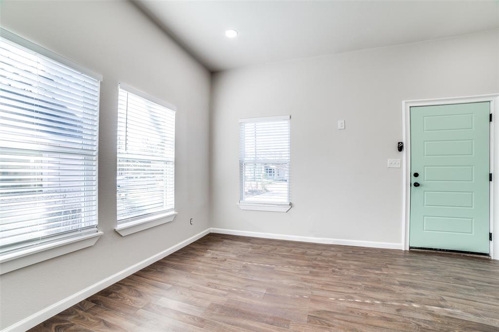 Foyer entrance with baseboards and wood finished floors