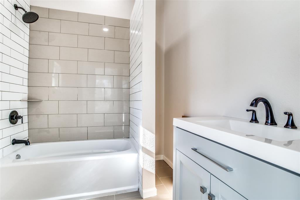 Bathroom featuring tile patterned floors, shower / bathing tub combination, and vanity