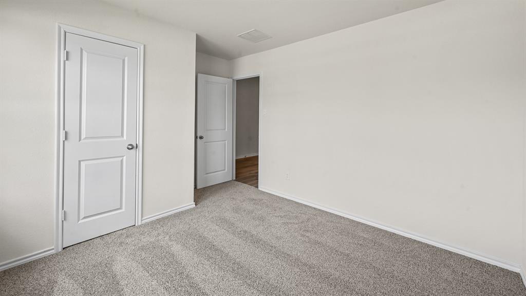 Neutral wall color with plush carpet flooring