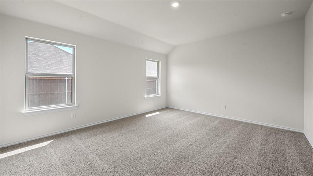 Vaulted ceiling with recessed lighting, two windows with white trim, and gray carpet