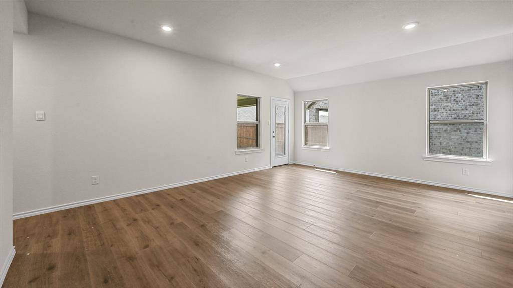Wood-finish flooring throughout, complemented by recessed lighting