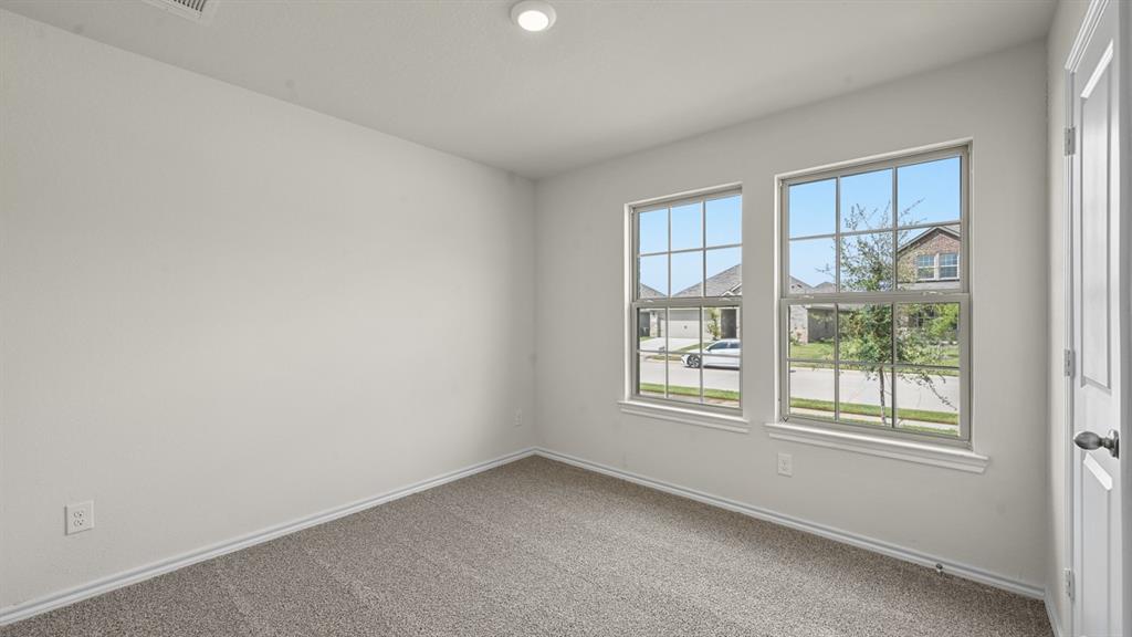 Carpeted flooring, white interior walls, two paneled windows, recessed ceiling lighting, and a white door