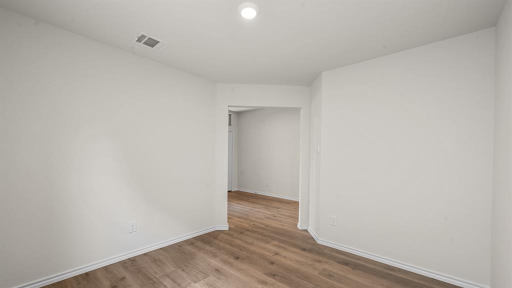 Recessed lighting, wood-finish flooring, and white painted walls