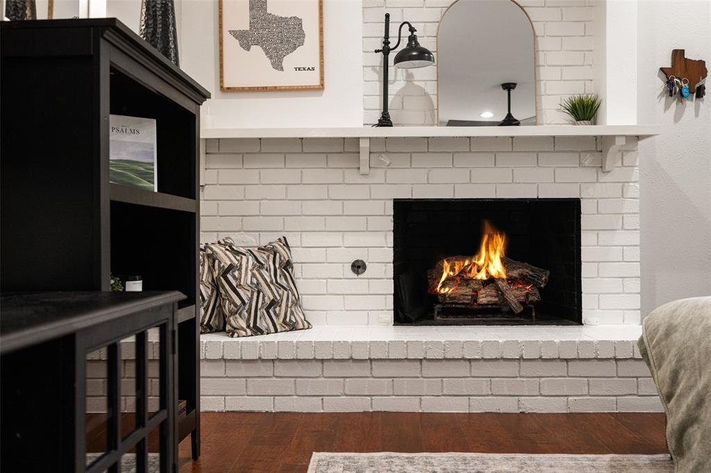 White painted brick fireplace with a substantial hearth and mantel