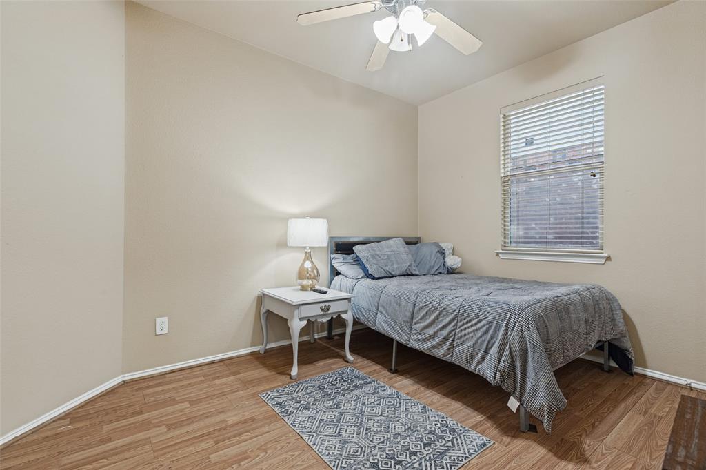 Wood-finish flooring, ceiling fan, and neutral wall tones